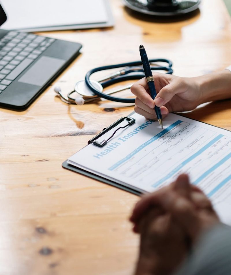 Female health insurance broker presenting his insurance benefits to businessman fill out insurance