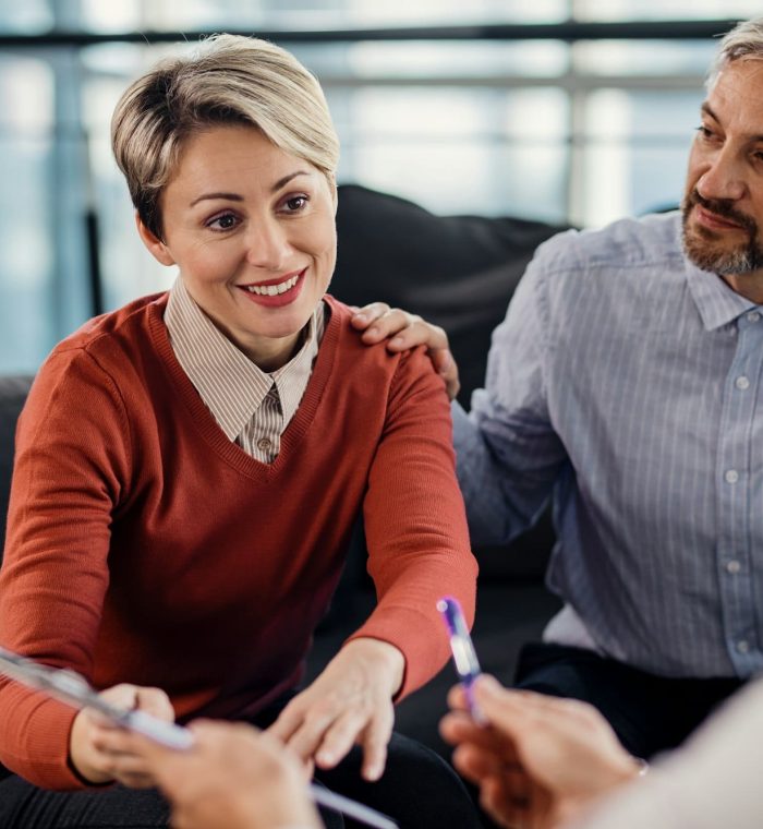 Mid adult couple making an agreement with their insurance agent on a meeting in the office.
